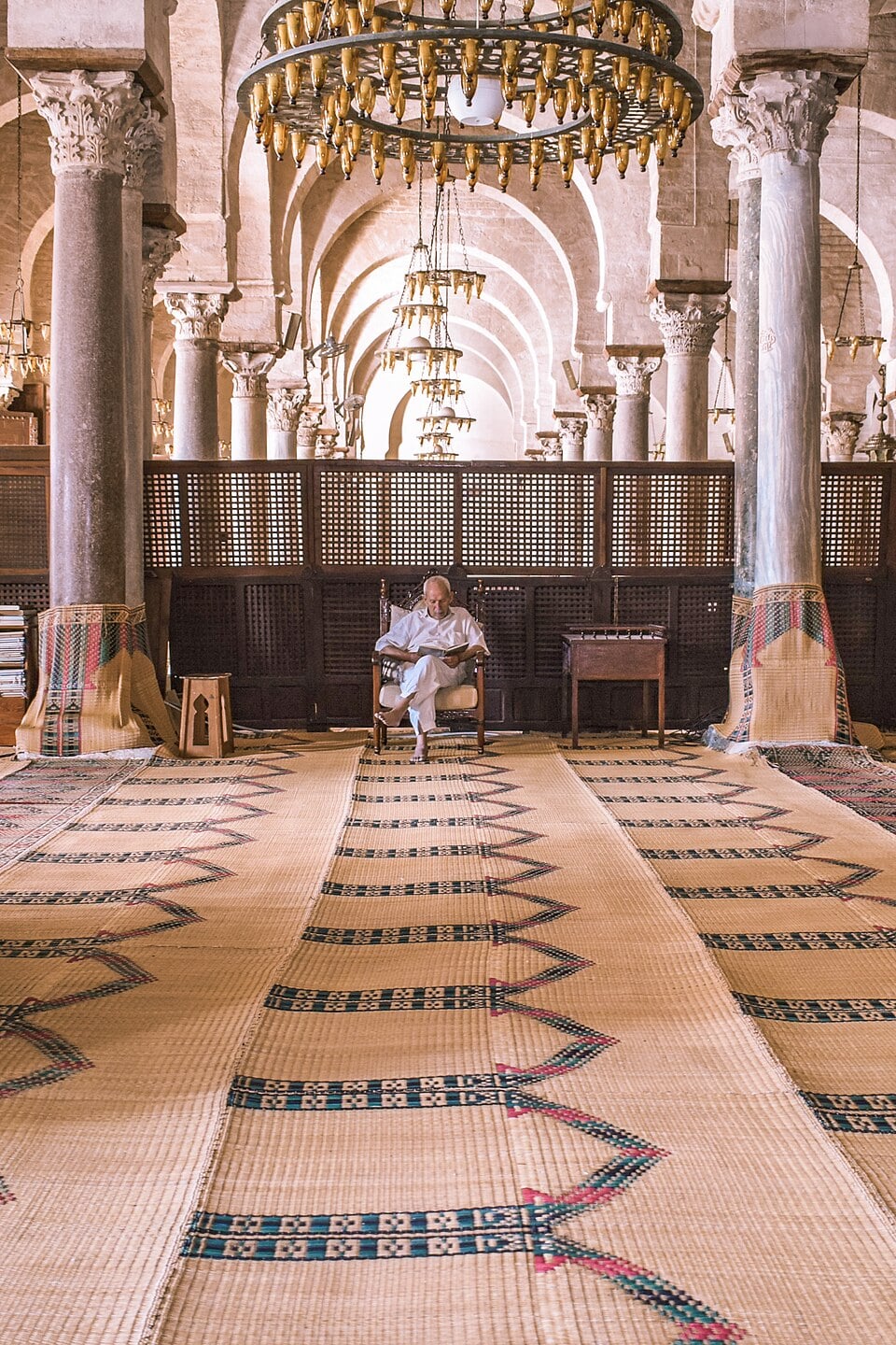 A reader at a low desk in the Kairouan mosque library.